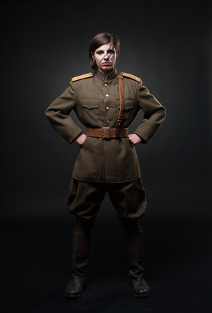 Woman in military uniform. Studio shot. Black backgroundの写真素材