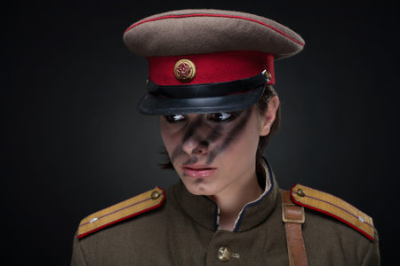 Woman in military uniform. Studio shot. Black backgroundの写真素材