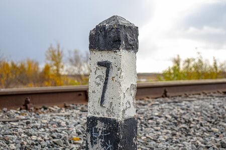 Railway. Signpost on the side of the railway. Granite mound on the railwayの写真素材
