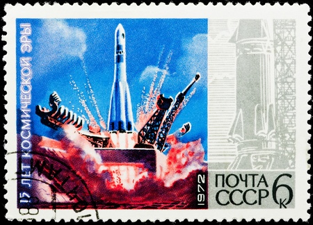 Postal stamp.  The space missile flies up from land in the blue sky. 17 years of a space age.の写真素材