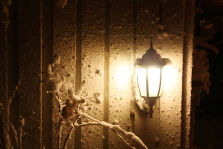 Lighting lamp on fence  in winter night の写真素材
