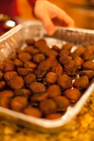chestnuts in an aluminum pan being removed from the ovenの写真素材