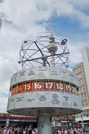 World clock at Alexanderplatz in Berlin with television tower in background. Modern architecture and art from the Soviet era.のeditorial素材