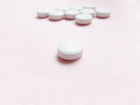 Single tablet close-up with a tablets background 