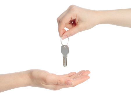 Human hands and keys isolated on white background の写真素材
