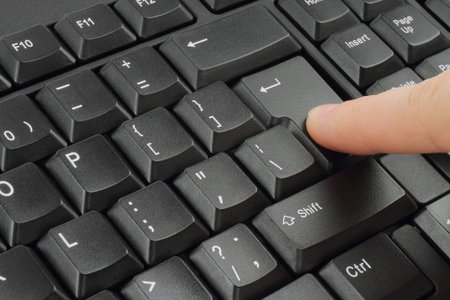 Finger pushing the button of keyboard