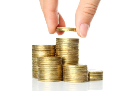 Hand put coins to stack of coins on white background