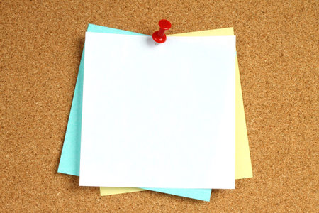 Color notes with pin on wooden background