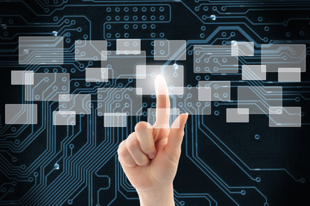 Woman hand using touch screen interface on circuit board backgroundの写真素材