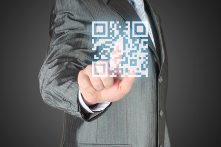 Businessman with hand pressing virtual qr code button
の写真素材
