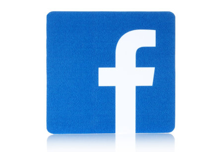 KIEV, UKRAINE - FEBRUARY 16, 2015: Facebook logo sign printed on paper and placed on white...