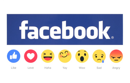Kiev, Ukraine - February 26, 2016: New Facebook like button 6 Empathetic Emoji Reactions printed on white paper. Facebook is a well-known social networking service.のeditorial素材