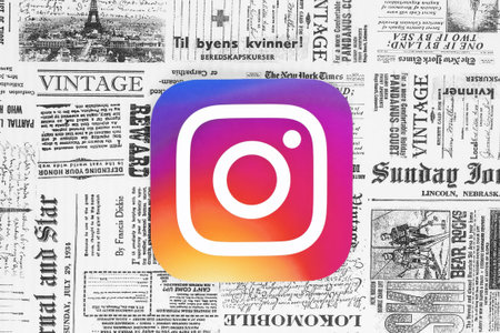 Kiev, Ukraine - February 08, 2018: Instagram icon printed on paper and placed on retro newspaper backgroundのeditorial素材