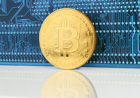 Bitcoin cryptocurrency coin on circuit board background close-up