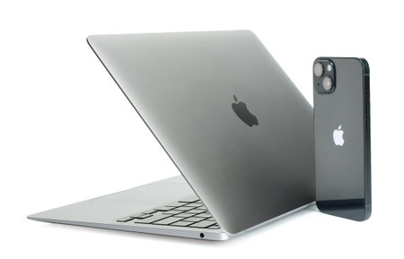 Kiev, Ukraine - May 02, 2022: Laptop Apple MacBook Air M1 13-inch with iPhone 13 on white background