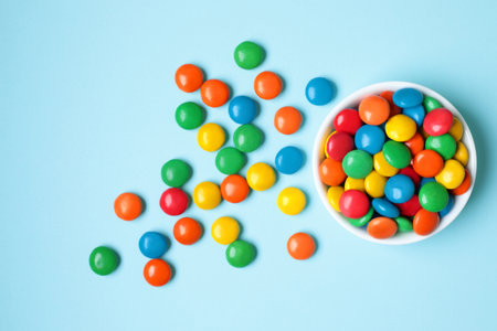 Vessel with Color Candies on blue background close-upの写真素材