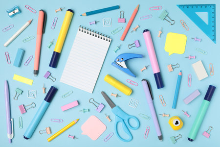 School and office supplies on blue background, mock-up top view close-up