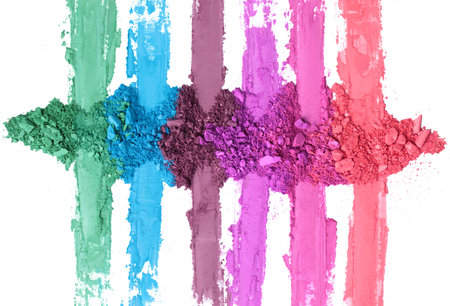 Broken and smashed color make-up eyeshadow palette, lay of brush strokes, on white background, top...