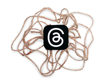 Threads mobile app icon with sackcloth threads on a white background close-up. Threads service...