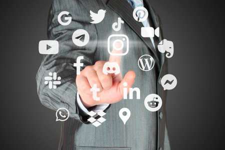 Man pushes virtual social media app icon on a dark background, connection to social media conceptのeditorial素材