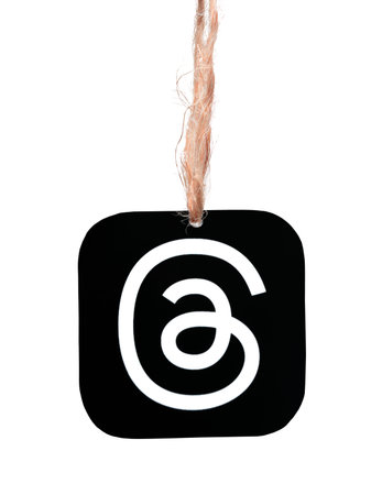 Threads mobile app icon hanging on sackcloth thread on a white background close-up. Meta Officially...