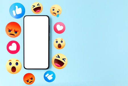 Smartphone with blank screen and icons of Facebook reacts on a blue background, social media conceptのeditorial素材