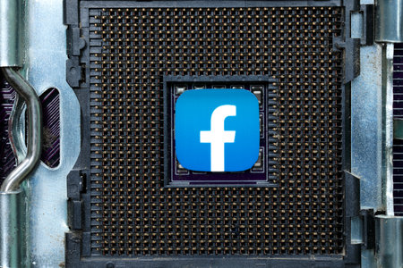 Facebook icon on a CPU Socket close-up, social media and technology conceptのeditorial素材