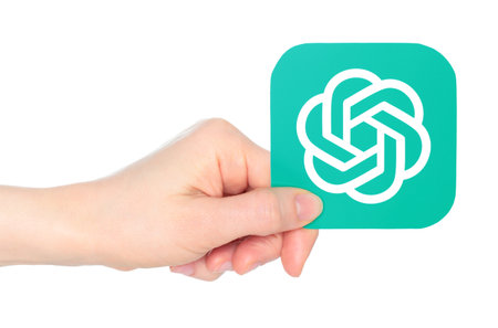 Hand holds paper OpenAI ChatGPT mobile app icon, on a transparent background. ChatGPT - Chat Generative Pre-trained Transformer is a chatbot developed by OpenAIのeditorial素材
