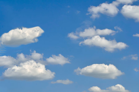 Beautiful background - white fluffy clouds on the blue sky