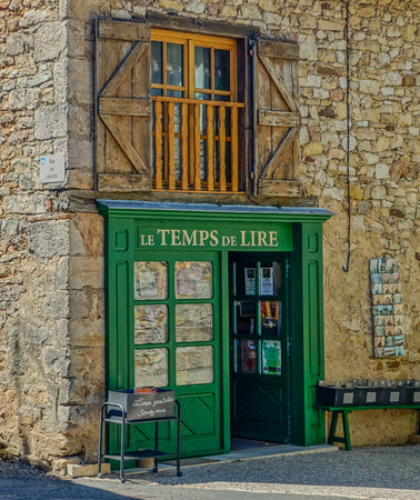 Stone facade of a village bookstore with decorative books in the entranceのeditorial素材
