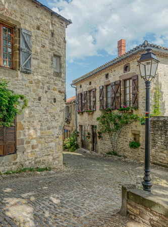 Typical narrow street of the village Cordes-sur-Ciel in Occitanie on a sunny dayのeditorial素材
