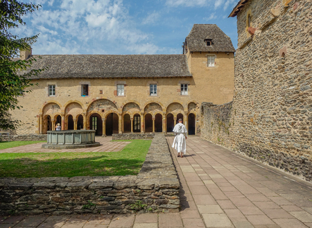 Fountain and arcade in the interior courtyard of the Conques monasteryのeditorial素材