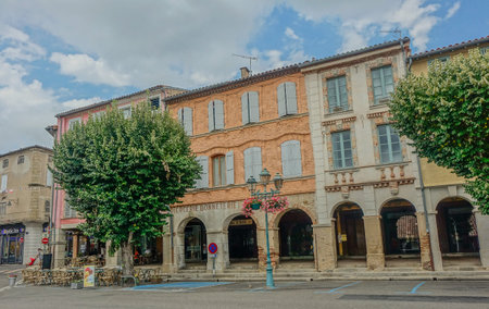 Street of buildings with arches and trees on a blue dayのeditorial素材