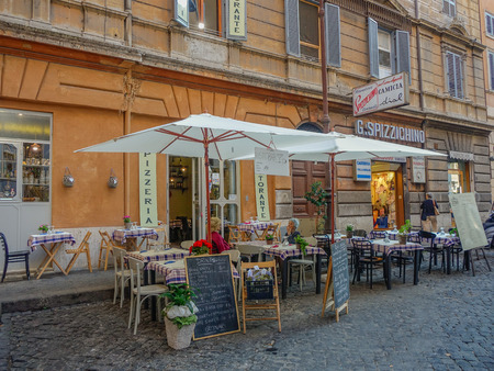 Scene of a street at sunset in Rome with people sitting on a terraceのeditorial素材