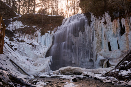 Frozen waterfall in the forest. Winter landscape with frozen waterfall.の写真素材