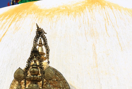 Gilded metallic decoration element placed atop a small shrine at the base of the white, yellow line paintedの写真素材