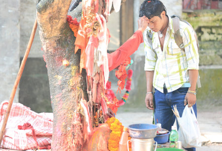 PHARPING, KATHMANDU/NEPAL - OCTOBER 4, 2012: Sadhu blesses hindu faithful nepali youngster's...