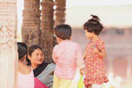 BHAKTAPUR, NEPAL - OCTOBER 5: Nepali women-little girls at play-open hall of the octagonal Chayslin Dega Mandap on October 5, 2012 in Durbar Square-Bhaktapur-Kathmandu Valley-Nepal.のeditorial素材