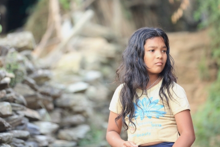 BANDIPUR, NEPAL - OCTOBER 6: Long haired teenage newar girl watches the contestants in a local beauty contest on October 6, 2012 in BandipurTanahu District-Gandaki Zone-Nepal.のeditorial素材