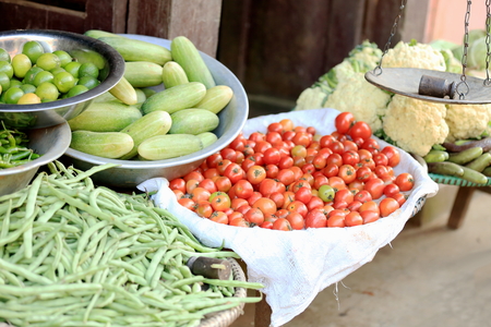 Groceries and vegetables shop showing a steelyard and some cauliflower, tomatoes, cucumbers, green beans   in Bandipur-Tanahu district-Gandaki zone-Nepal の写真素材