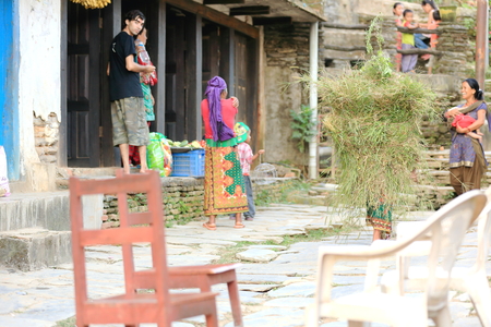 BANDIPUR, NEPAL - OCTOBER 07: Nepali people at their house.s doors easily chat at sunset after a workday on October 7, 2012 in Bandipur-Tanahu district-Gandaki zone-Nepal.のeditorial素材