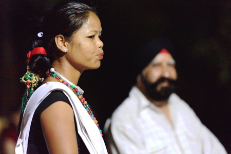 PATIHANI, NEPAL - OCTOBER 13: Girl of the Tharu people in their traditional dressing performs music and dance for the tourists in the Safari Narayani Lodge on October 13, 2012 in Ghatgain-Patihani-Chitwan distr.-Narayani zone-Nepal.のeditorial素材