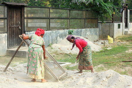 CHITWAN, NEPAL - OCTOBER 14: Local women work in maintenance tasks of the Gharial Conservation Program facilities on October 14, 2012. Chitwan Nnal.Park and distr.-Narayani zone-Nepal.のeditorial素材