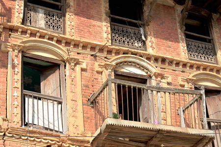 Traditional newar style house showing red brick facade with wooden balconies-windows-windowsills facing the old city area. Dhulikhel-Kavrepalanchok distr.-Bagmati zone-Nepal.の写真素材