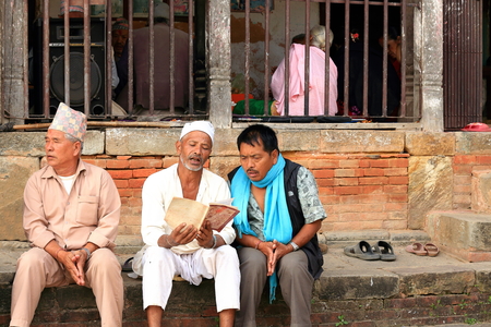 PANAUTI, NEPAL - OCTOBER 16: Nepalese-hindu devotees pray and sing religious psalms outside the Sattal-Pilgrim.s house at Tribheni Ghat-Khware shrine area-Punyamati and Roshi rivers junction on October 16, 2012. Panauti-Nepal.のeditorial素材