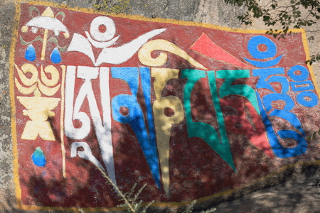 Tibetan buddhist painting on mani stone -om mani padme hum- in the Drepung-Rice Heap monastery of the Gelugpa-Yellow Hat School at the foot of mount Ghephel. Lhasa pref.-Tibet A.R.-China.のeditorial素材