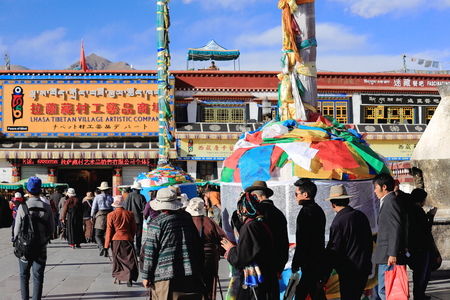 LHASA, TIBET, CHINA - OCTOBER 19: Tibetan buddhist devotees do the Kora-clockwise circumambulation around the Jokhang-House of Buddha temple on October 19, 2012 in Lhasa-Tibet A.R.-China.のeditorial素材