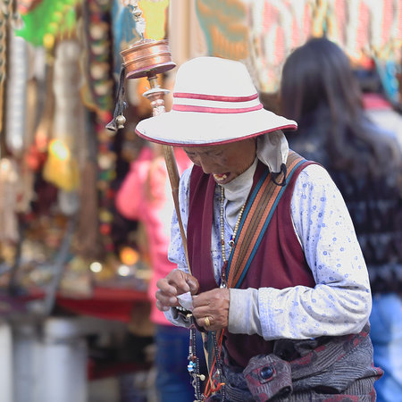LHASA, TIBET, CHINA - OCTOBER 19: Tibetan buddhist devotee does the Kora-clockwise circumambulation around the Jokhang-House of Buddha temple on October 19, 2012 in Lhasa-Tibet A.R.-China.のeditorial素材