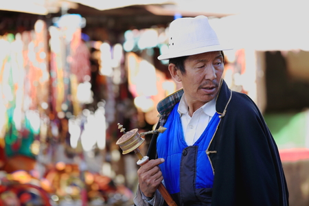 LHASA TIBET CHINA  OCTOBER 19: Tibetan buddhist devotee does the Koraclockwise circumambulation around the JokhangHouse of Buddha temple on October 19 2012 in LhasaTibet.のeditorial素材