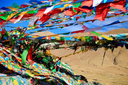 Buddhist prayer flags under blue sky waving in the wind in the Nachan Lapass at 4500 ms.high over the KyichuLhasa river valley to the NE.from Lhasa Lhasa pref.Tibet A.R.China.の写真素材